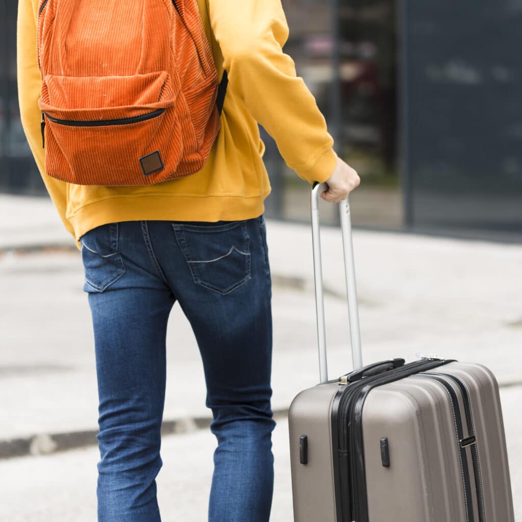 silhouette of man holding luggage inside airport